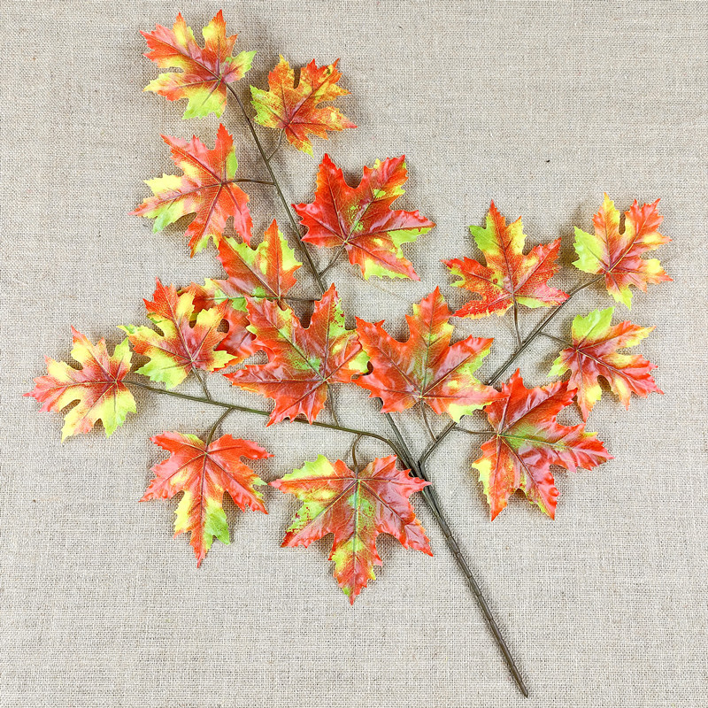 Artificial poplar and maple leaves with a tactile feel, coated with glue to resemble fake tree branches and leaves.