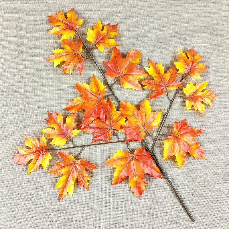 Artificial poplar and maple leaves with a tactile feel, coated with glue to resemble fake tree branches and leaves.