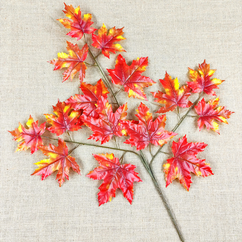 Artificial poplar and maple leaves with a tactile feel, coated with glue to resemble fake tree branches and leaves.