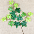 Artificial poplar and maple leaves with a tactile feel, coated with glue to resemble fake tree branches and leaves.