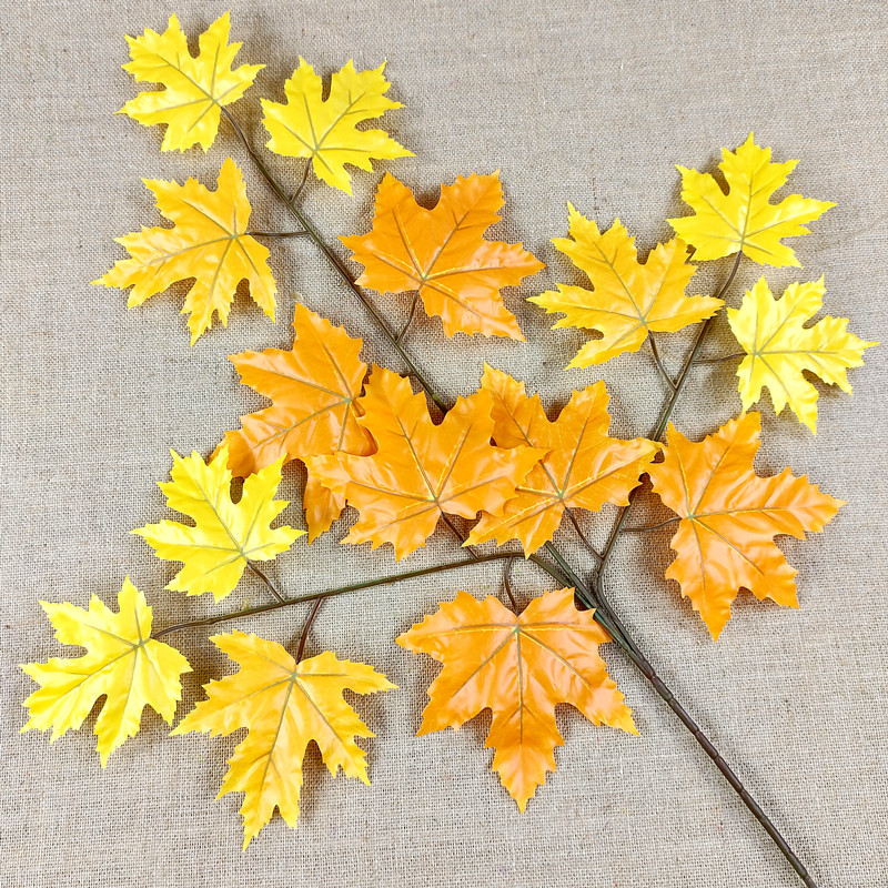 Artificial poplar and maple leaves with a tactile feel, coated with glue to resemble fake tree branches and leaves.
